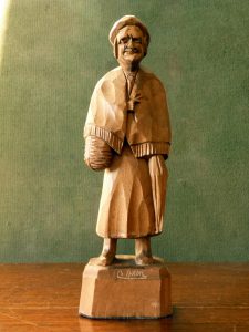 Caron carved wood figure of an old woman